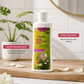 Fiabila Herbal Hand & Foot Cream bottle displayed on a wooden surface with decorative props including a potted plant, scattered petals, and informational text callouts.
