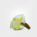 Yellow bath bomb with a brown ribbon on a light gray background