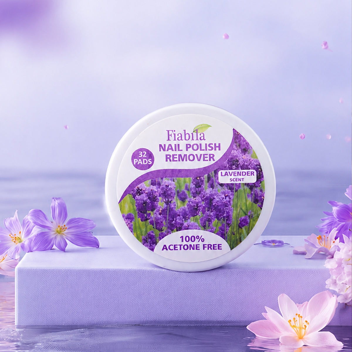 A round container of Fiabla Nail Polish Remover in lavender scent, displayed on a lavender pedestal with purple flowers around it against a soft purple background.