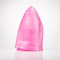 A translucent pink silicone hair cap with a textured bubble pattern, standing upright on a reflective white surface against a white background.