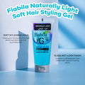 A tube of Fiabila Naturally Light Soft Hair Styling Gel stands on a light blue studio surface with text callouts around it. The product tube is bright blue with a silver cap and black/white branding.